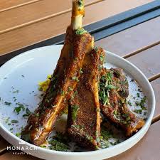 Ajja signature dishes Lamb Ribs, Charred Carrots with Labneh, Whole Grilled Fish, various dips with fresh pita